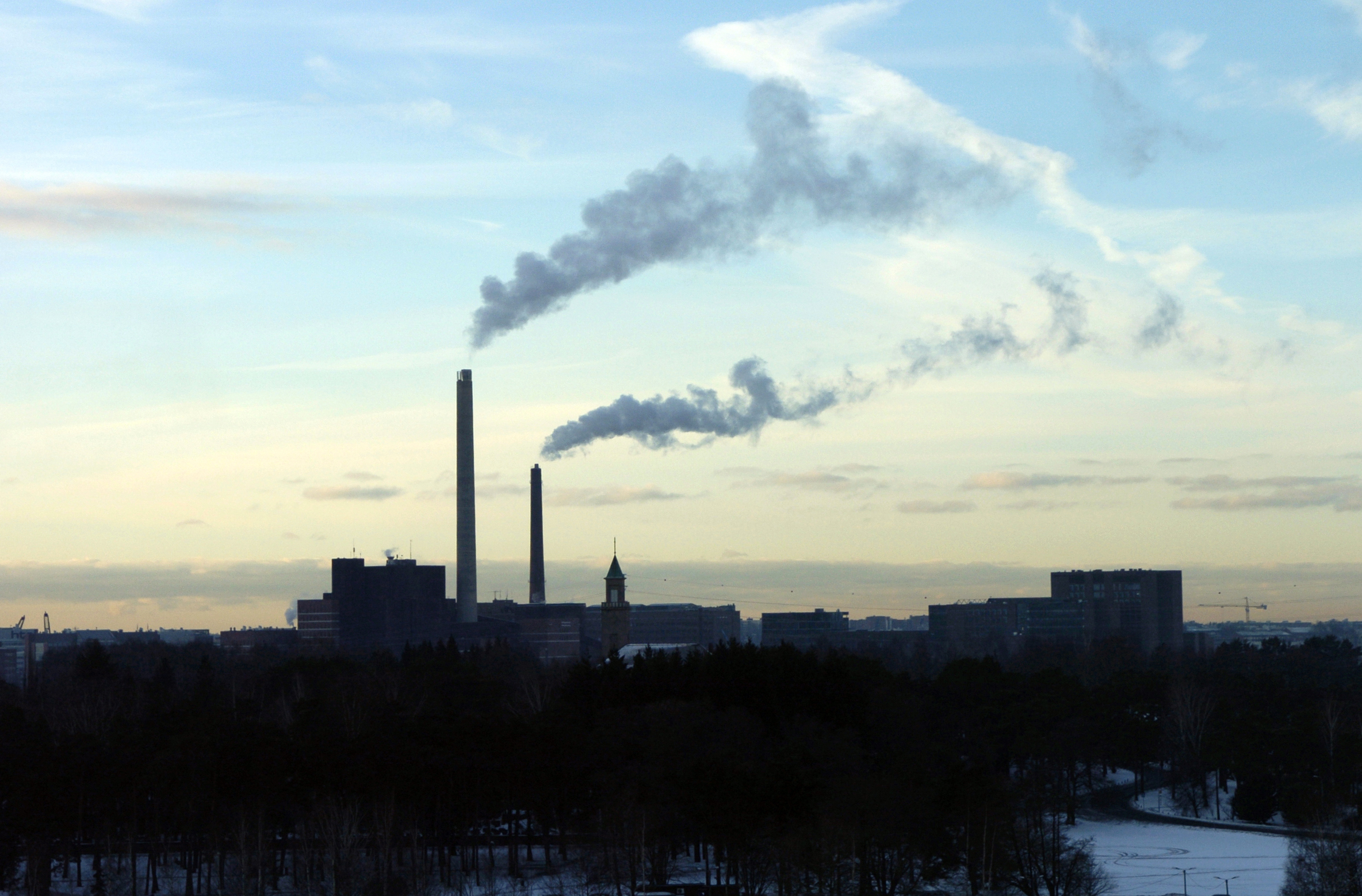 View of power plant smoke against the sky. 